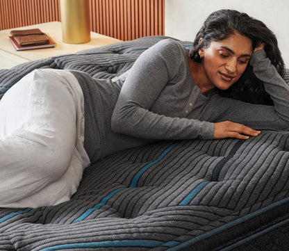 Woman resting on Beautyrest Core Level 2 Medium Firm Pillow Top Innerspring Mattress