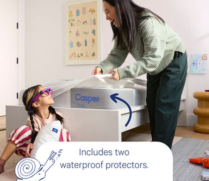 Woman and Child smiling around Casper Snug Kid's Mattress, featuring waterproof protectors