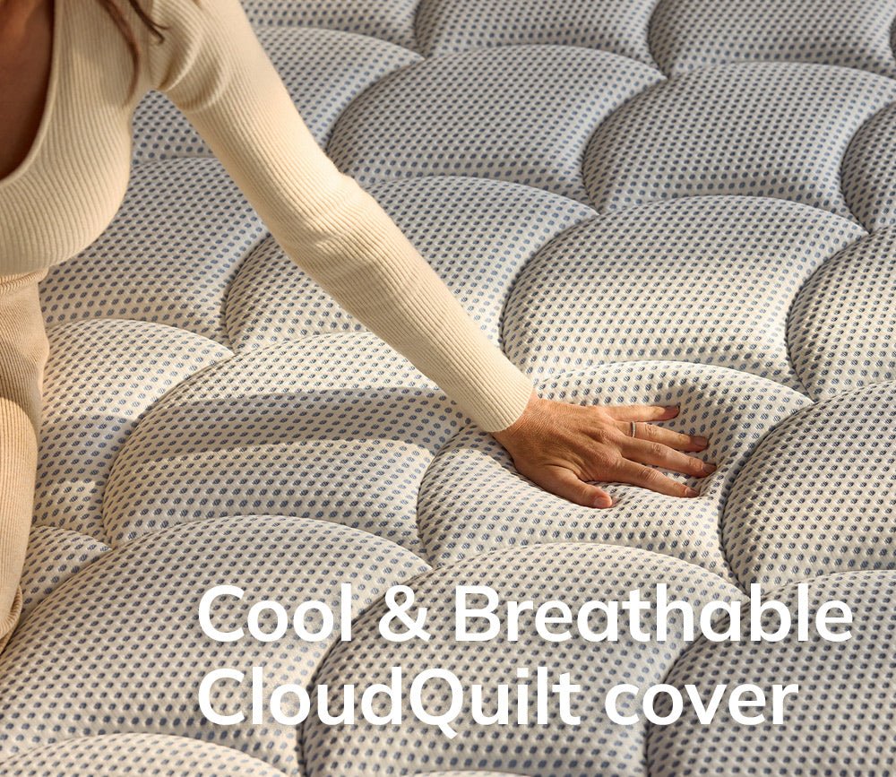 Hand pressing on DreamCloud 4.0 Premier Hybrid Mattress showcasing its cool and breathable CloudQuilt cover.