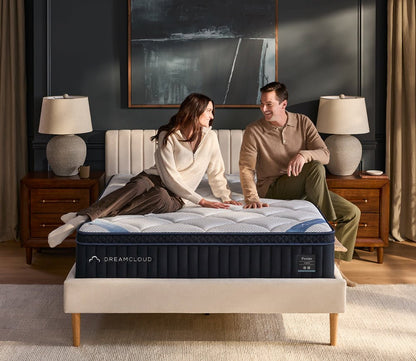 Womand and man sitting on DreamCloud 4.0 Premier Hybrid Mattress by DreamCloud.