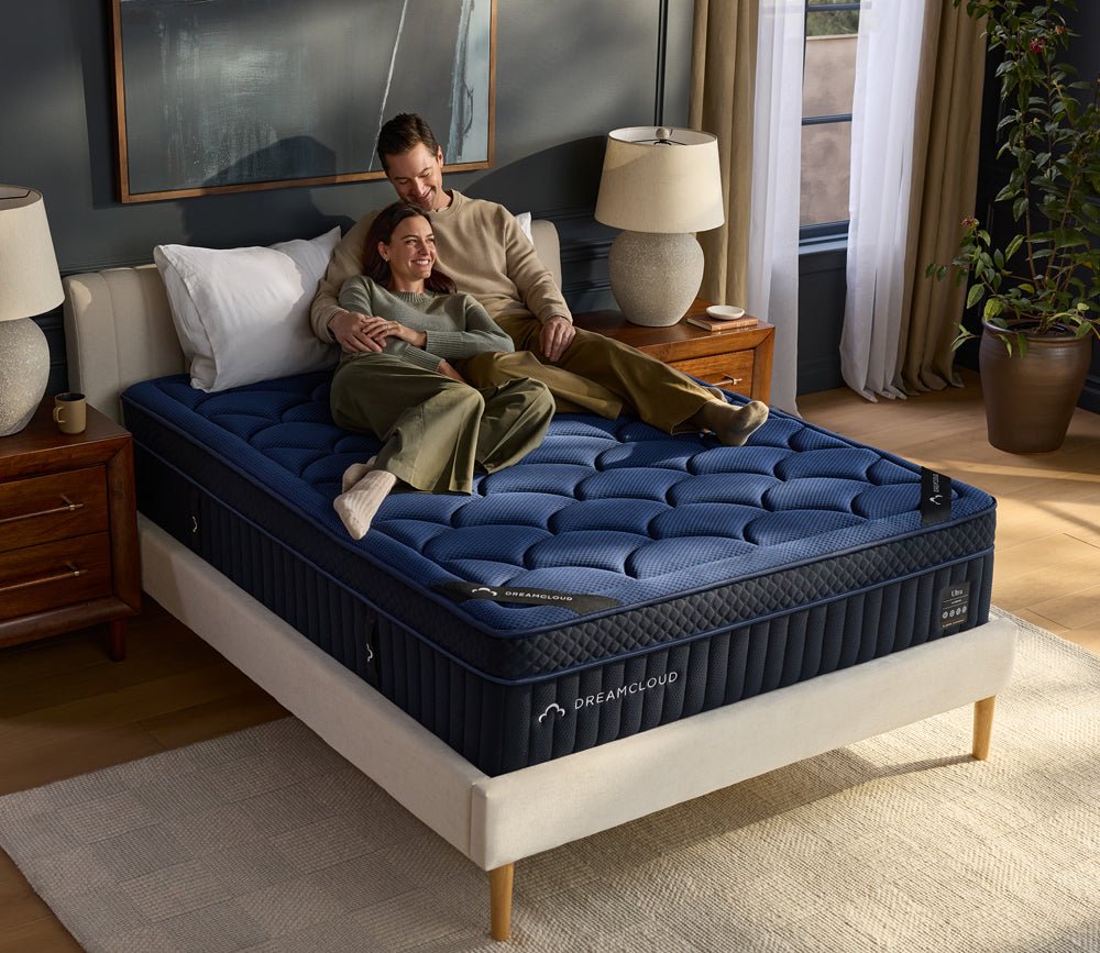 Couple resting on DreamCloud 4.0 Ultra Hybrid Mattress by DreamCloud.