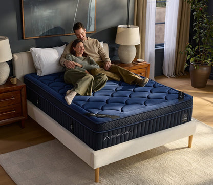 Couple resting on DreamCloud 4.0 Ultra Hybrid Mattress by DreamCloud.