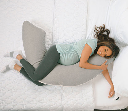 Pregnant model side sleeping on Dual-Sided U-Shaped Body Pillow by Bedgear