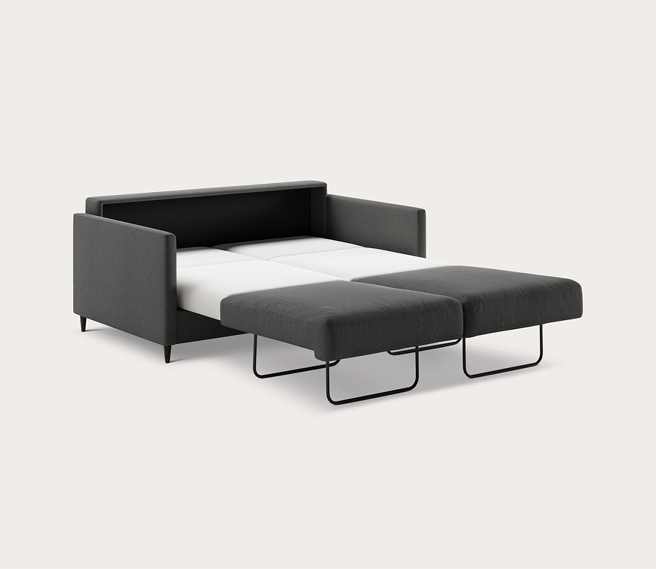 Queen Elfin Sleeper Sofa in dark gray fully extended into a bed with a pull-out sleeping surface - angled
