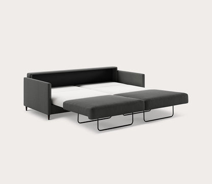 Elfin Sleeper Sofa in dark gray fully extended into a bed with a pull-out sleeping surface - angled
