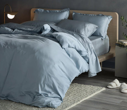 Hush Iced Pillowcase Set by Hush Blankets, in light blue, on bed