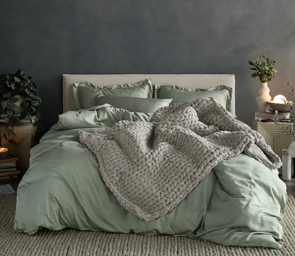 Hush Knit Weighted Blanket by Hush Blankets in light gray on bed