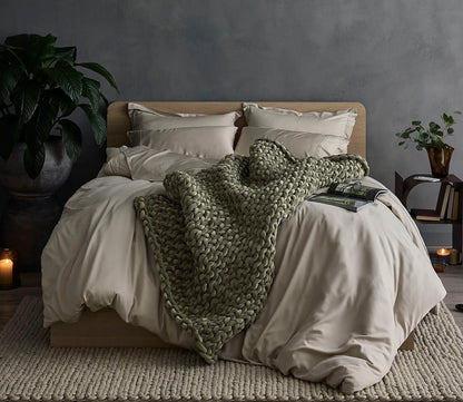 Hush Knit Weighted Blanket by Hush Blankets in olive on bed