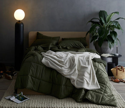 Hush Luxe Throw by Hush Blankets in ivory shown on bed