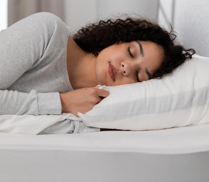 Iced Cooling Sheet Set by Hush Blankets, model resting on white sheets