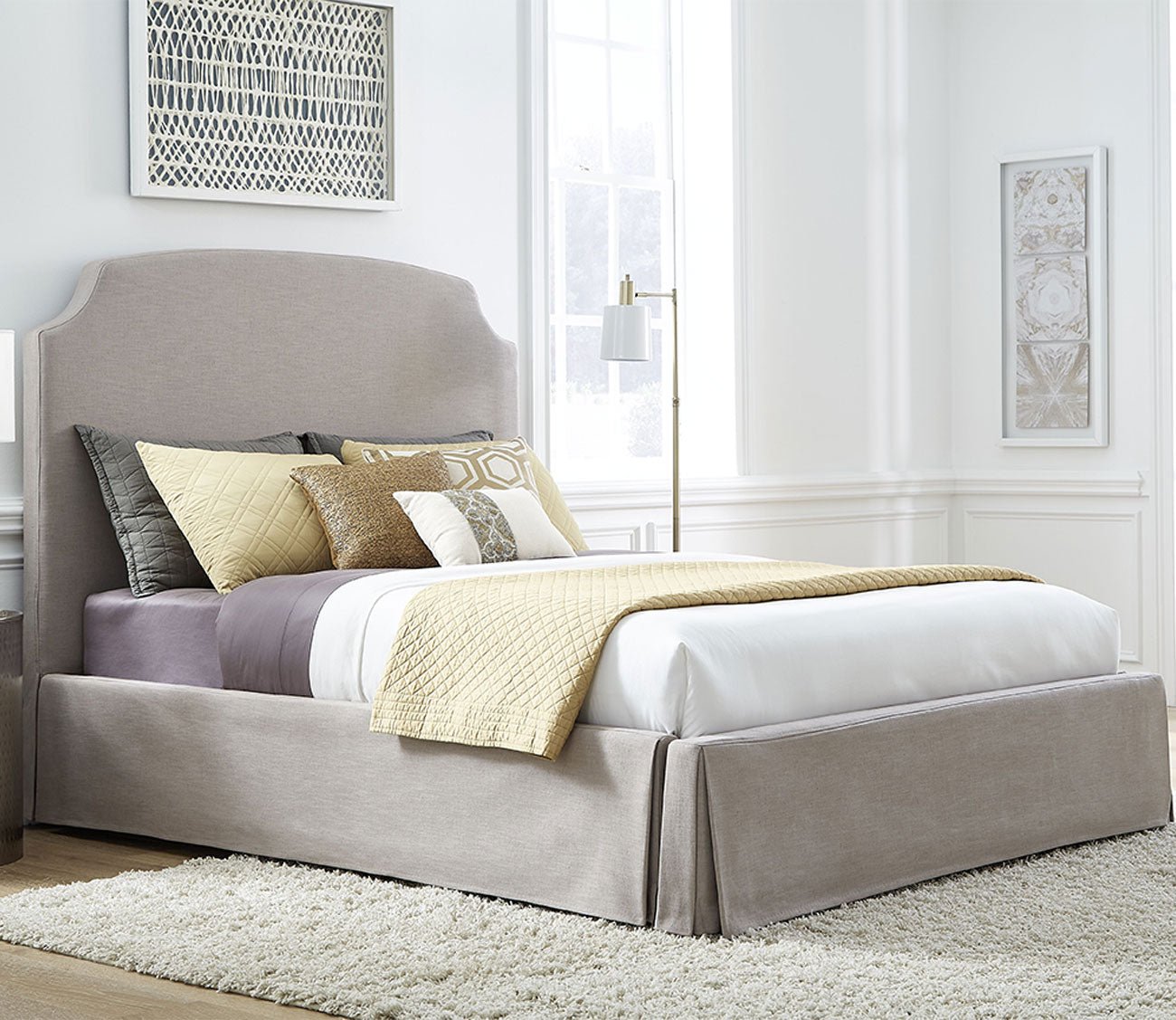 Laurel Upholstered Skirted Storage Panel Bed lifestyle angled view