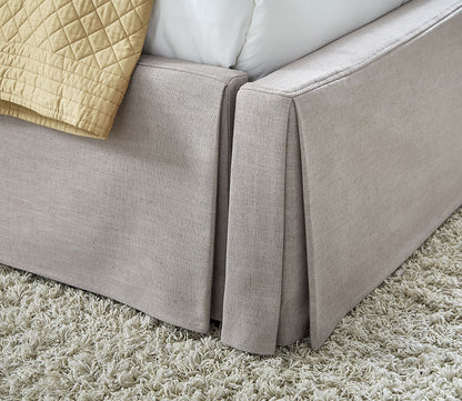 Skirt close-up of Laurel Upholstered Skirted Storage Panel Bed