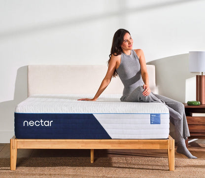 A woman resting on a Nectar 5.1 Classic Hybrid Mattress by Nectar