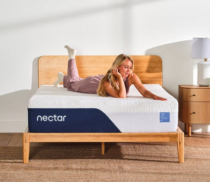A woman resting on Nectar 5.1 Classic Memory Foam Mattress.