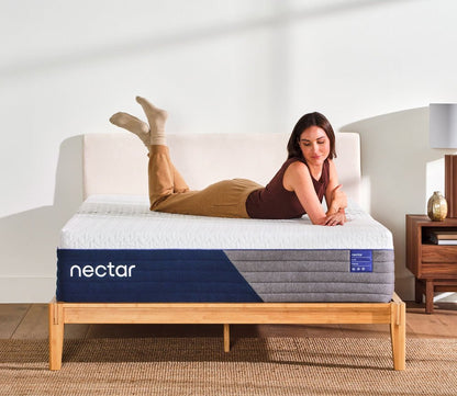 Woman resting on Nectar 5.1 Luxe Hybrid Mattress.
