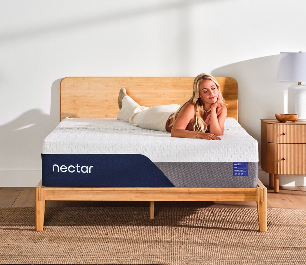 Woman resting comfortably on a Nectar 5.1 Luxe Memory Foam Mattress .