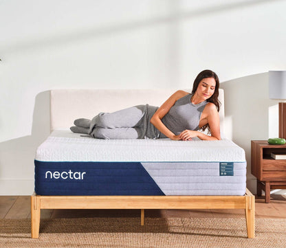 Woman resting on her side on a Nectar 5.1 Premier Hybrid Mattress by Nectar