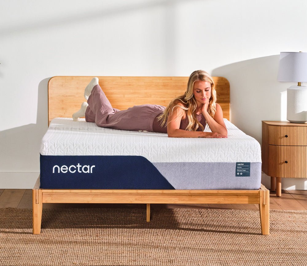 Woman resting on Nectar 5.1 Premier Memory Foam Mattress.
