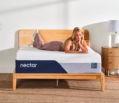 Woman resting on Nectar 5.1 Premier Memory Foam Mattress.