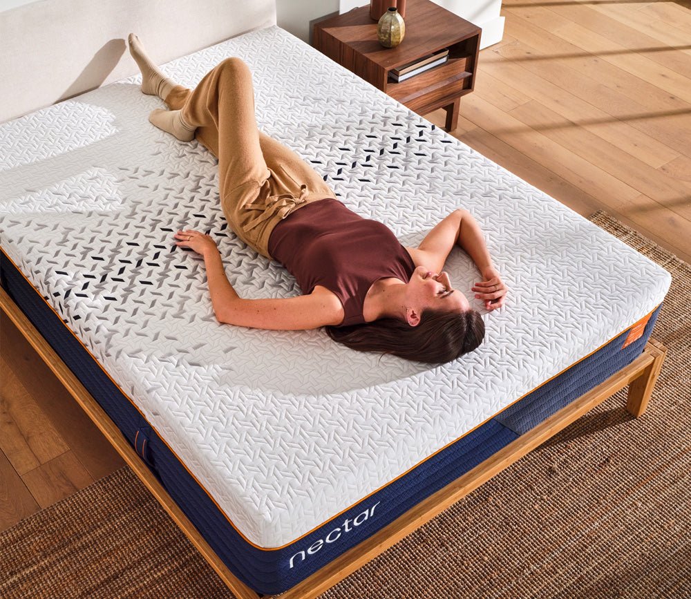 Lifestyle image of a woman relaxing on a Nectar mattress.