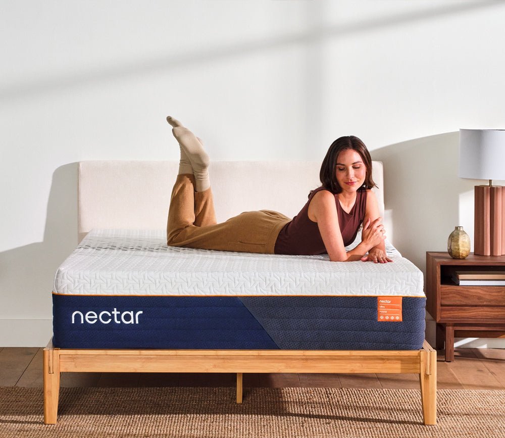 Woman resting on a Nectar mattress while lying on her stomach.