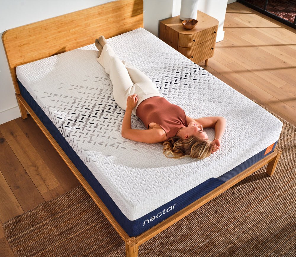 Overhead view of a woman relaxing on a Nectar mattress.