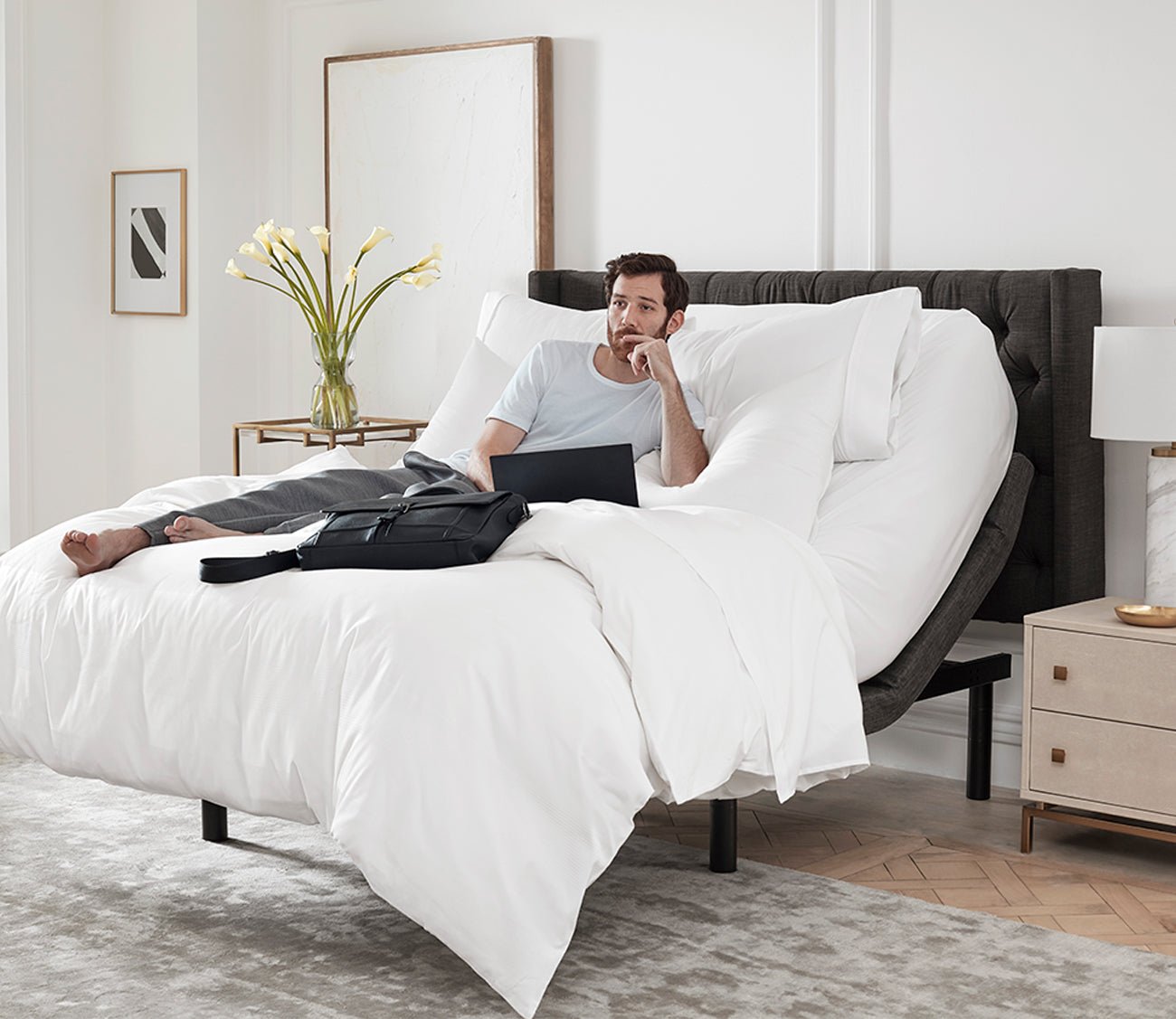 S5000 Adjustable Bed Base by Sleeptone, man working in bed with head up