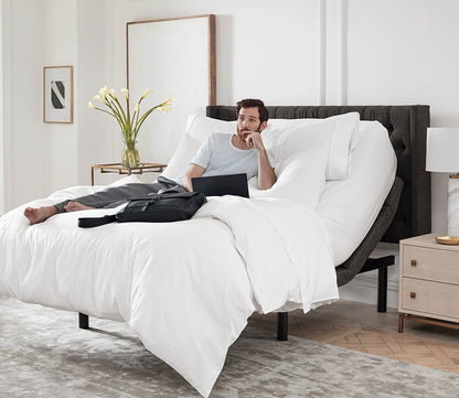 S5000 Adjustable Bed Base by Sleeptone, man working in bed with head up