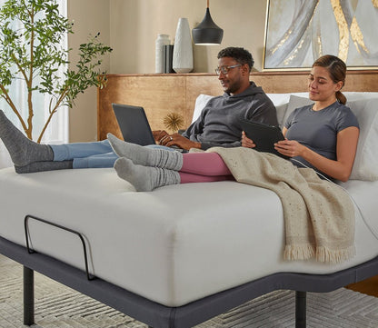 Serta Baselogic Gold Adjustable Base by Serta, couple relaxing in bed with head and legs adjusted