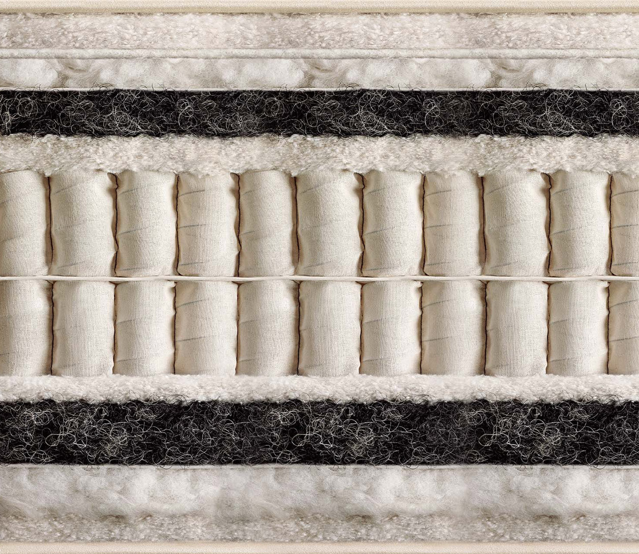 Cross-section of a Vispring mattress showing natural fiber comfort layers and hand-nested pocket springs.